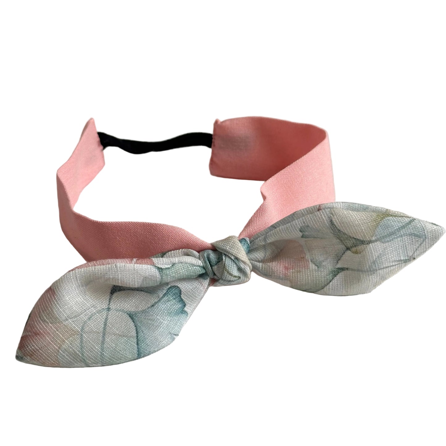 Soft pink baby headband with pastel floral knot bow and elastic back for toddlers.